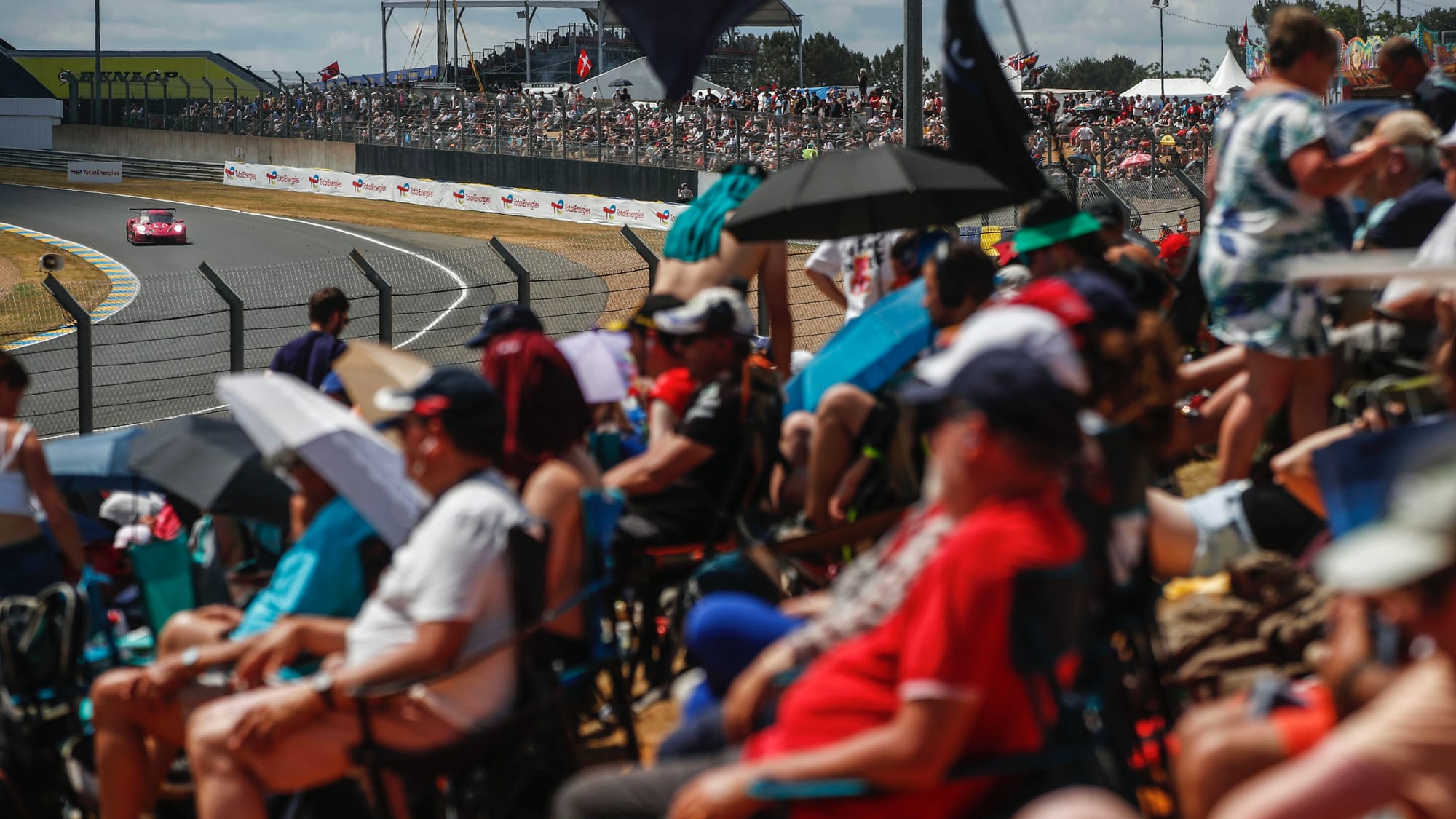 Fans watch Sarah Bovy, Rahel Frey and Michelle Gatting's Porsche at the Le Mans 24 Hours, 2023