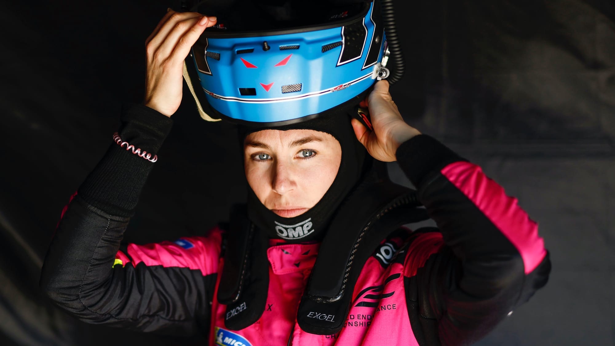 Iron Dames driver Rahel Frey putting on a helmet