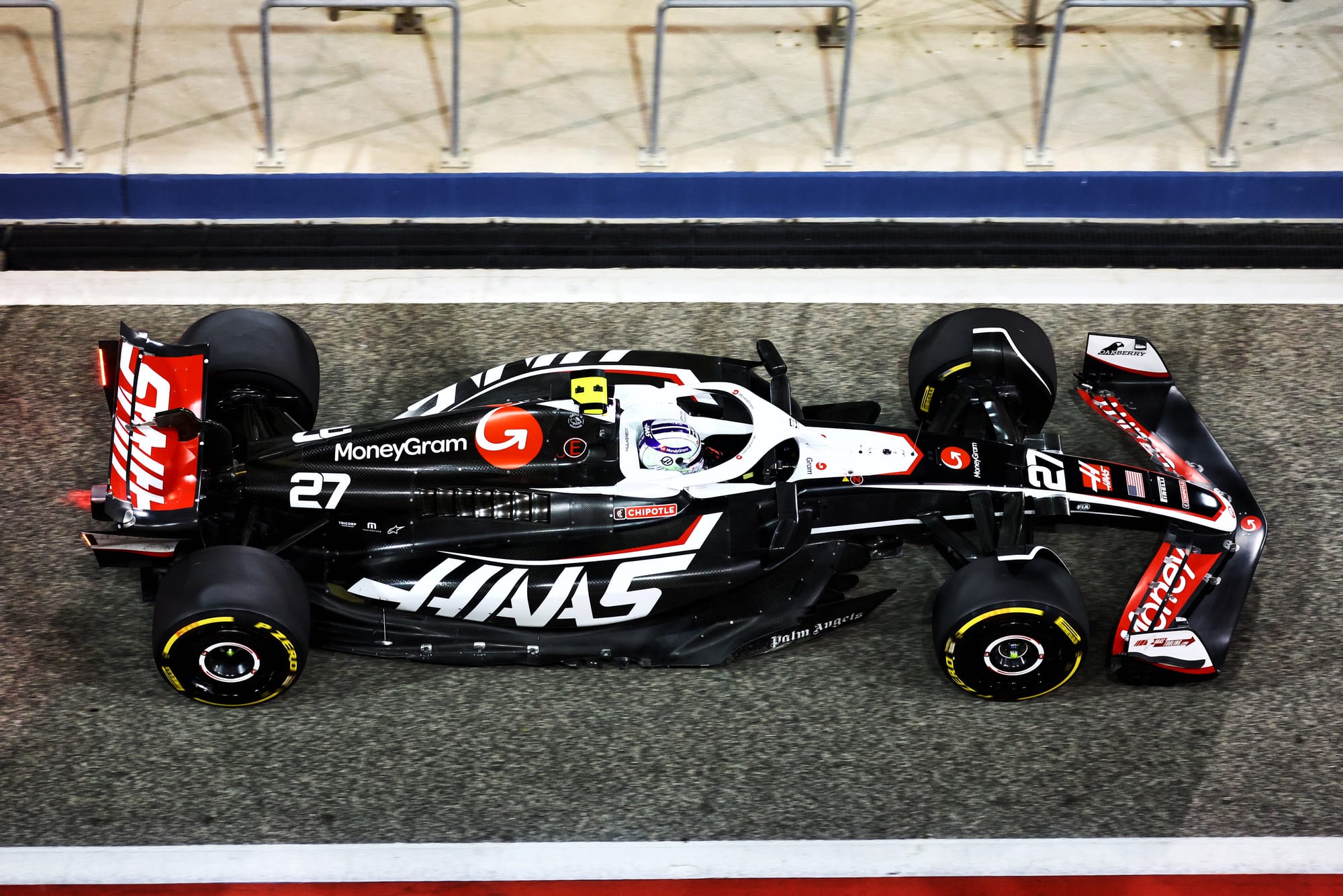 An overhead shot of the Haas F1 car with the front on the right and rear on the left in Bahrain F1 testing, 2024