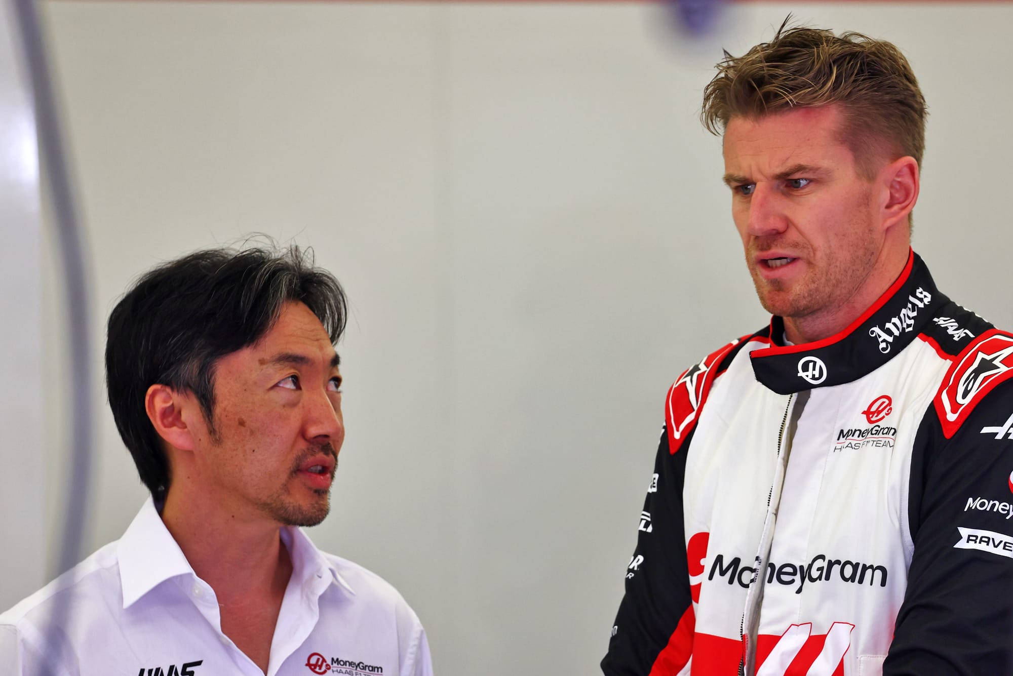 Haas team principal Ayao Komatsu looks at his driver Nico Hulkenberg in Bahrain F1 testing, 2024