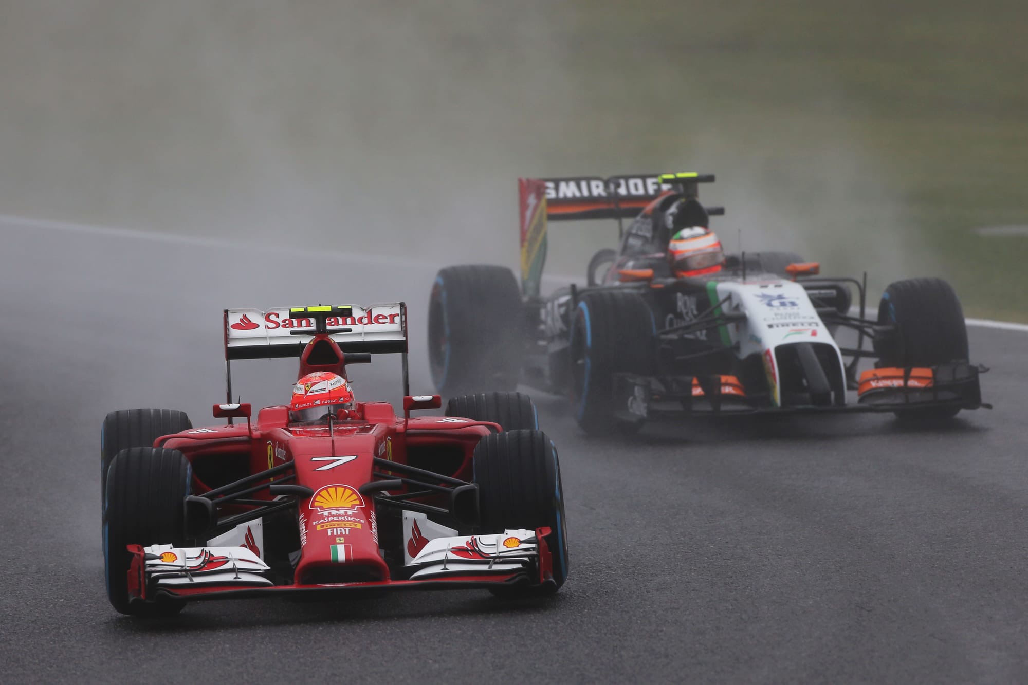 Kimi Raikkonen's Ferrari leads Sergio Perez's Force India in 2014